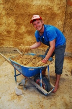 James mixing clay, sand, water and hay